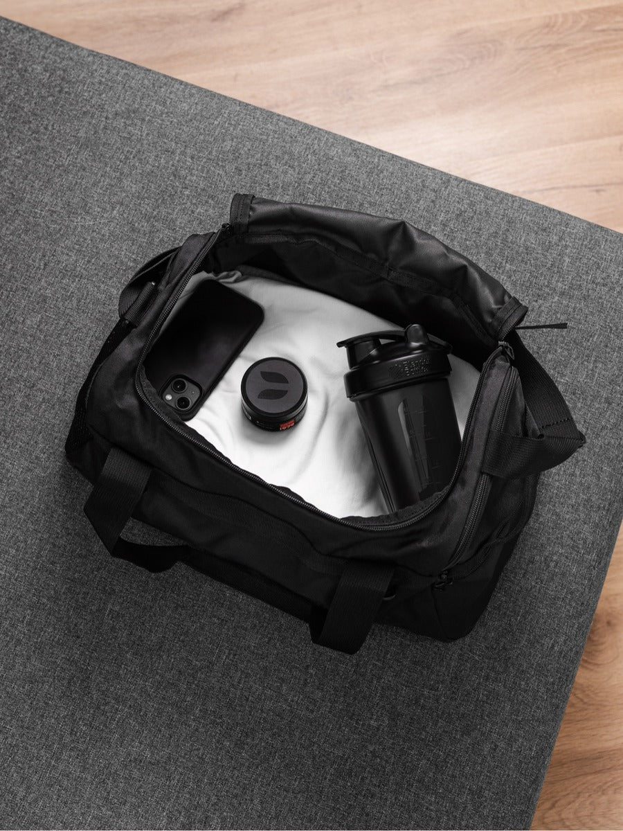 DASH FOR HIM hair clay jar inside a gym bag — the post-workout hair reset kit