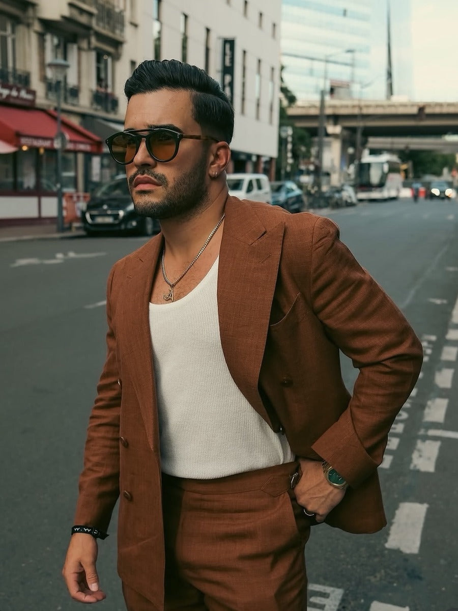 How to use hair clay: man with a textured, natural-finish style wearing a rust-brown suit